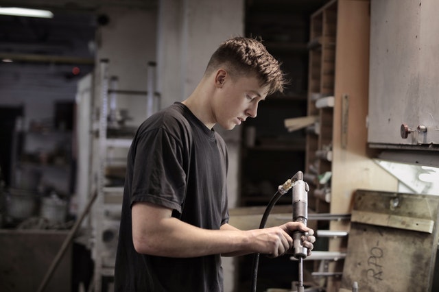 young-mechanic-attentively-working-in-workshop-3846390